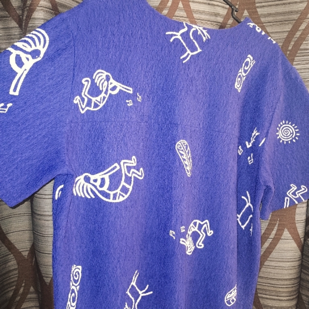 A woman's purple blouse made by Maxima. XL